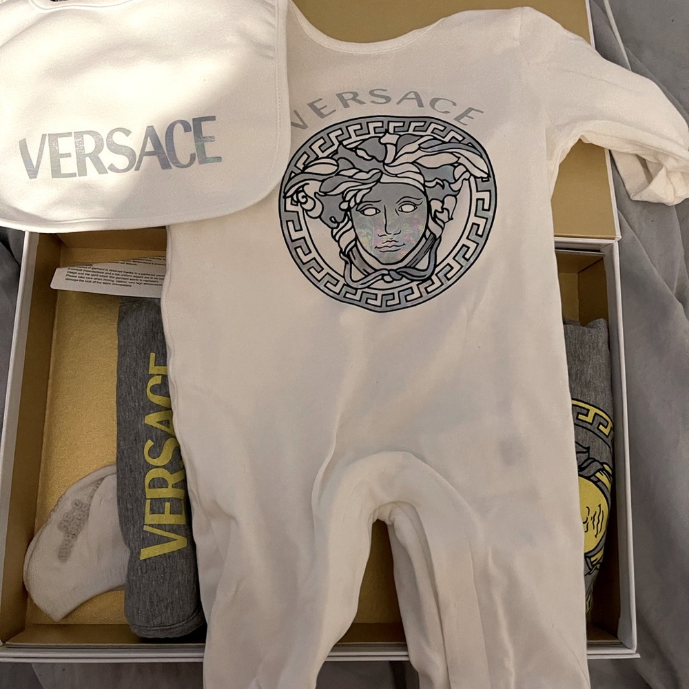 Size 0-3 month Versace outfit it’s 2 outfits one cream/white other grey 2bibs